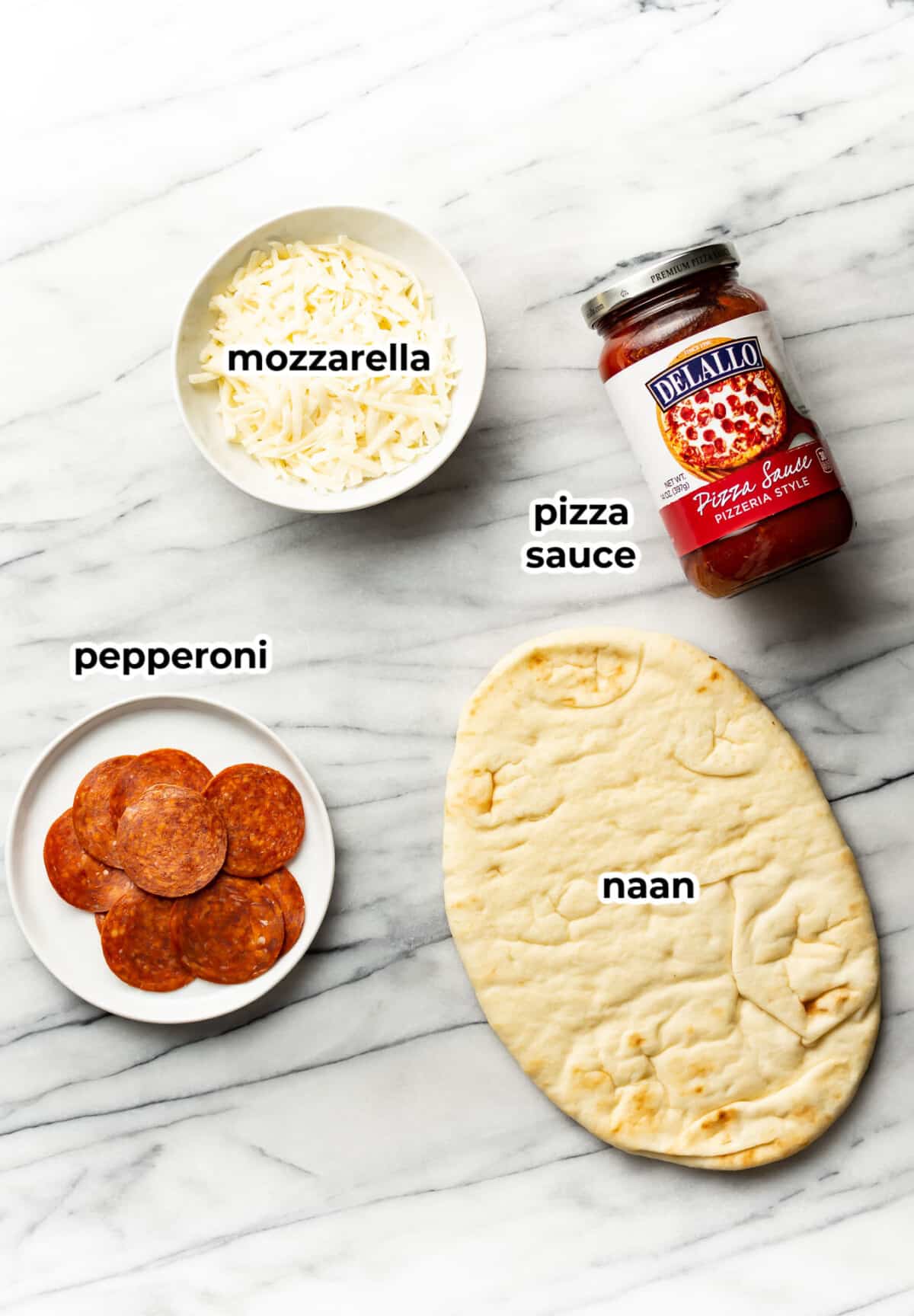 ingredients for naan pizza in prep bowls