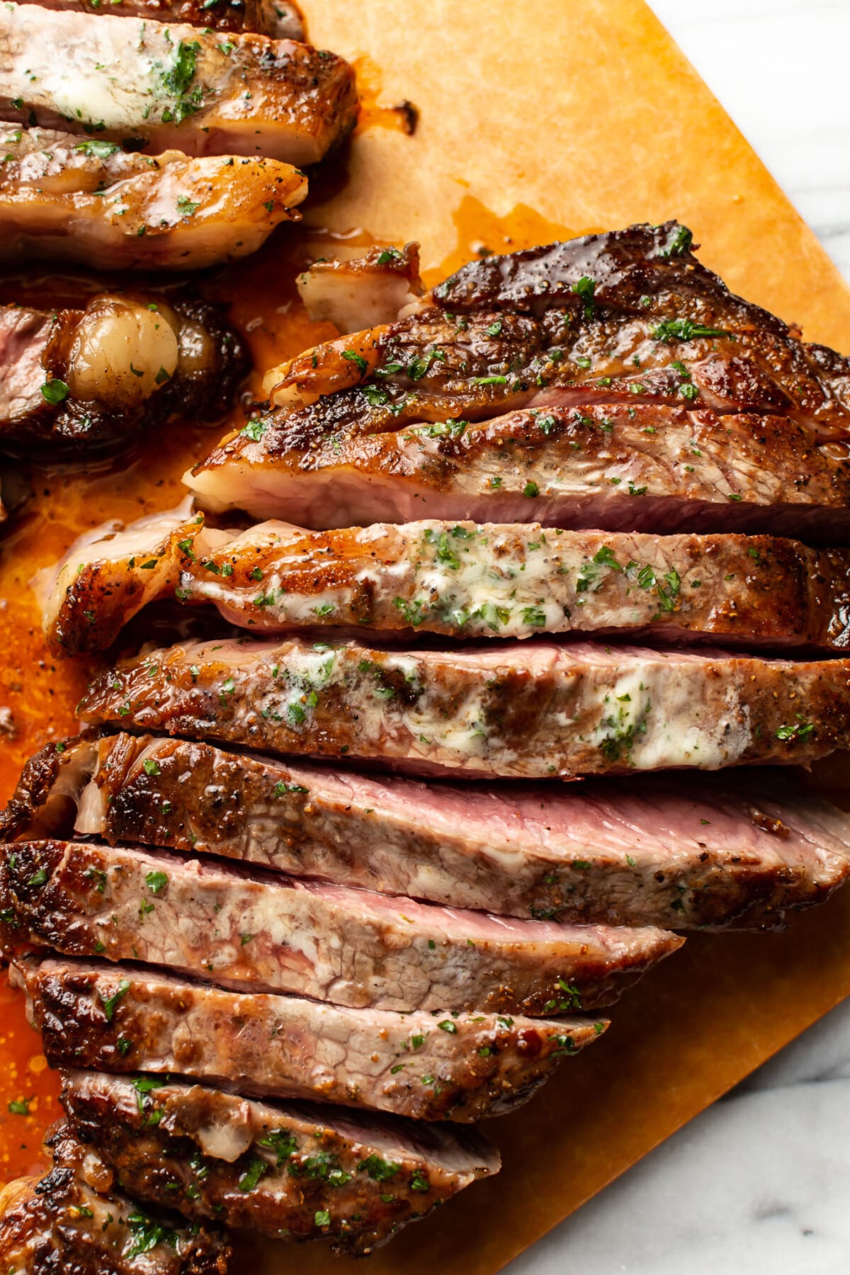 sliced ribeye steak on a cutting board