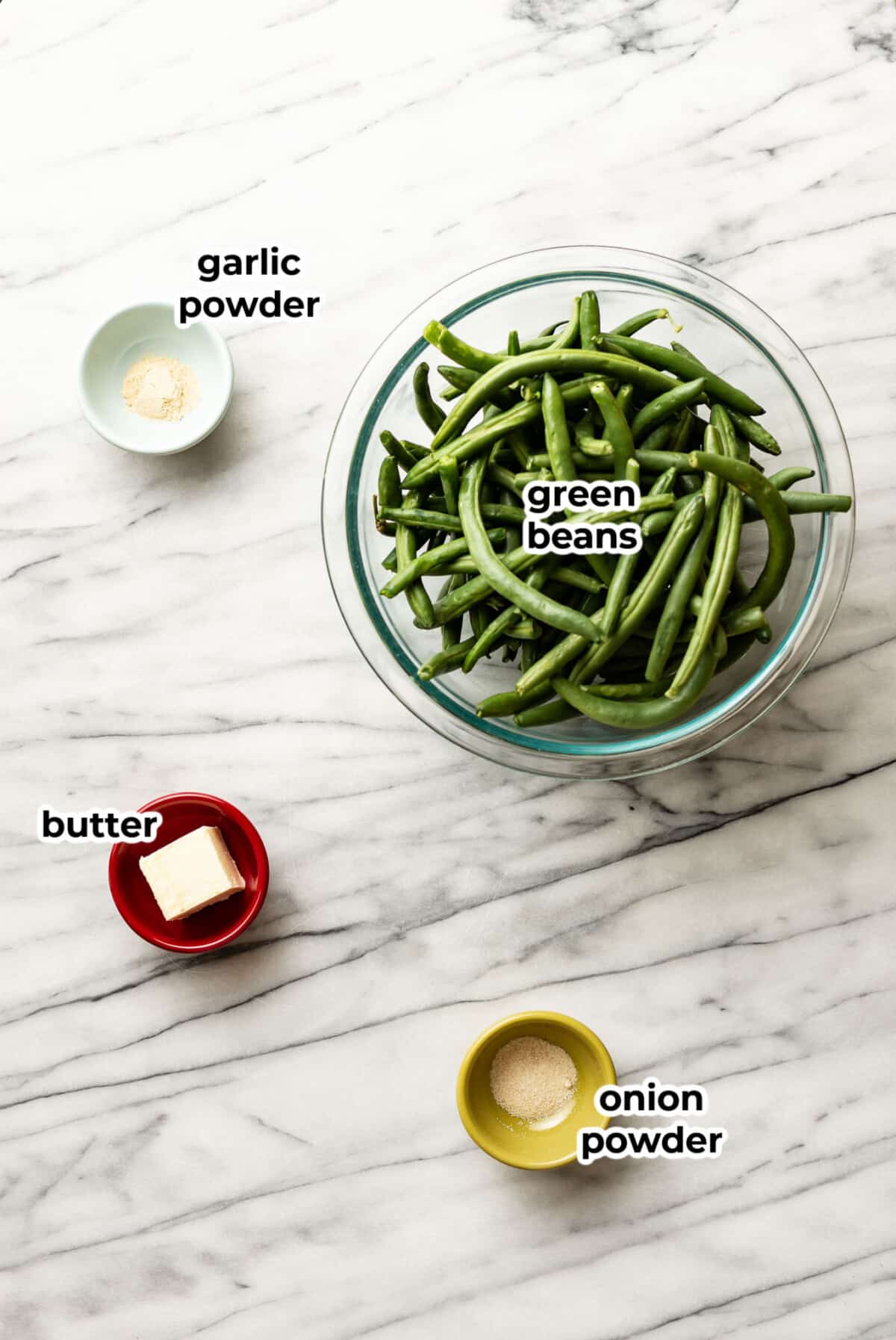 ingredients for sauteed green beans in prep bowls