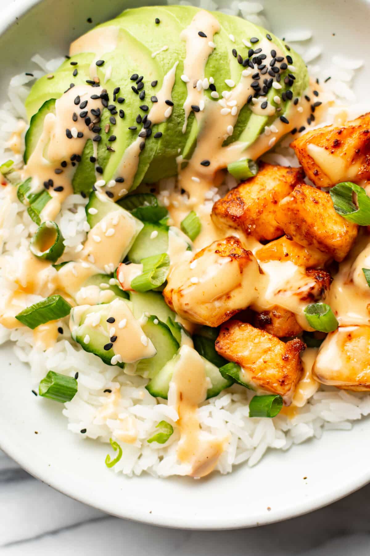 a bowl with air fryer salmon bites, rice, and avocado